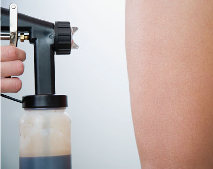 Best custom airbrush sunless tanning solution being sprayed on skin.